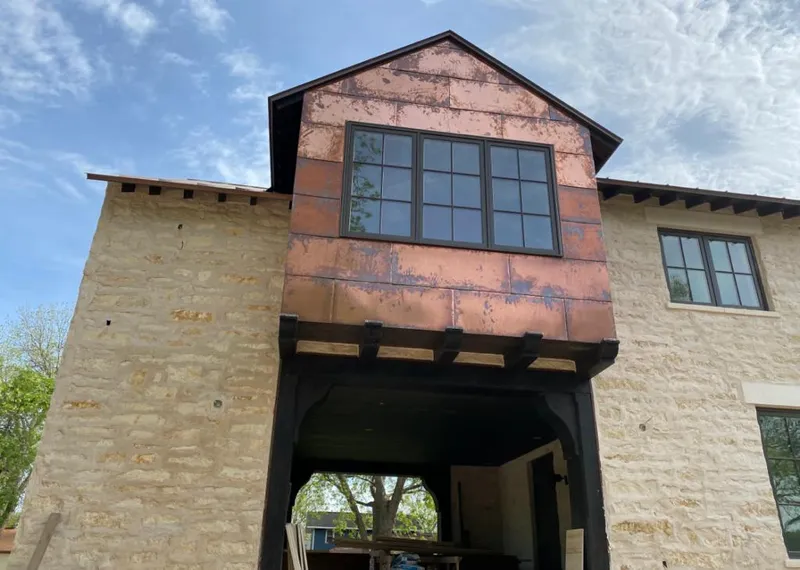 Copper metal panel facade on a stone building for Metal Roof Coating in Highland